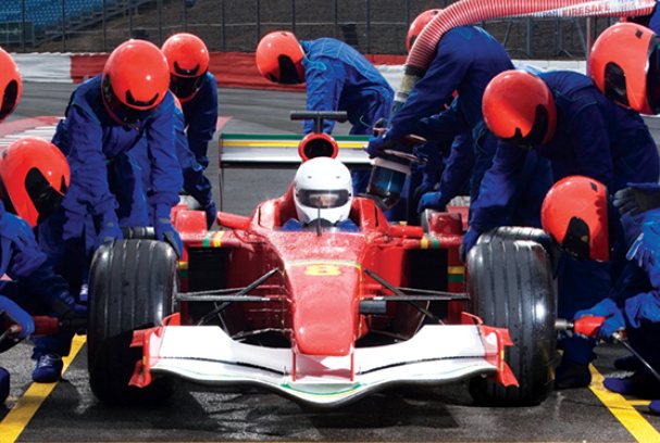 A pit crew services a race car in seconds